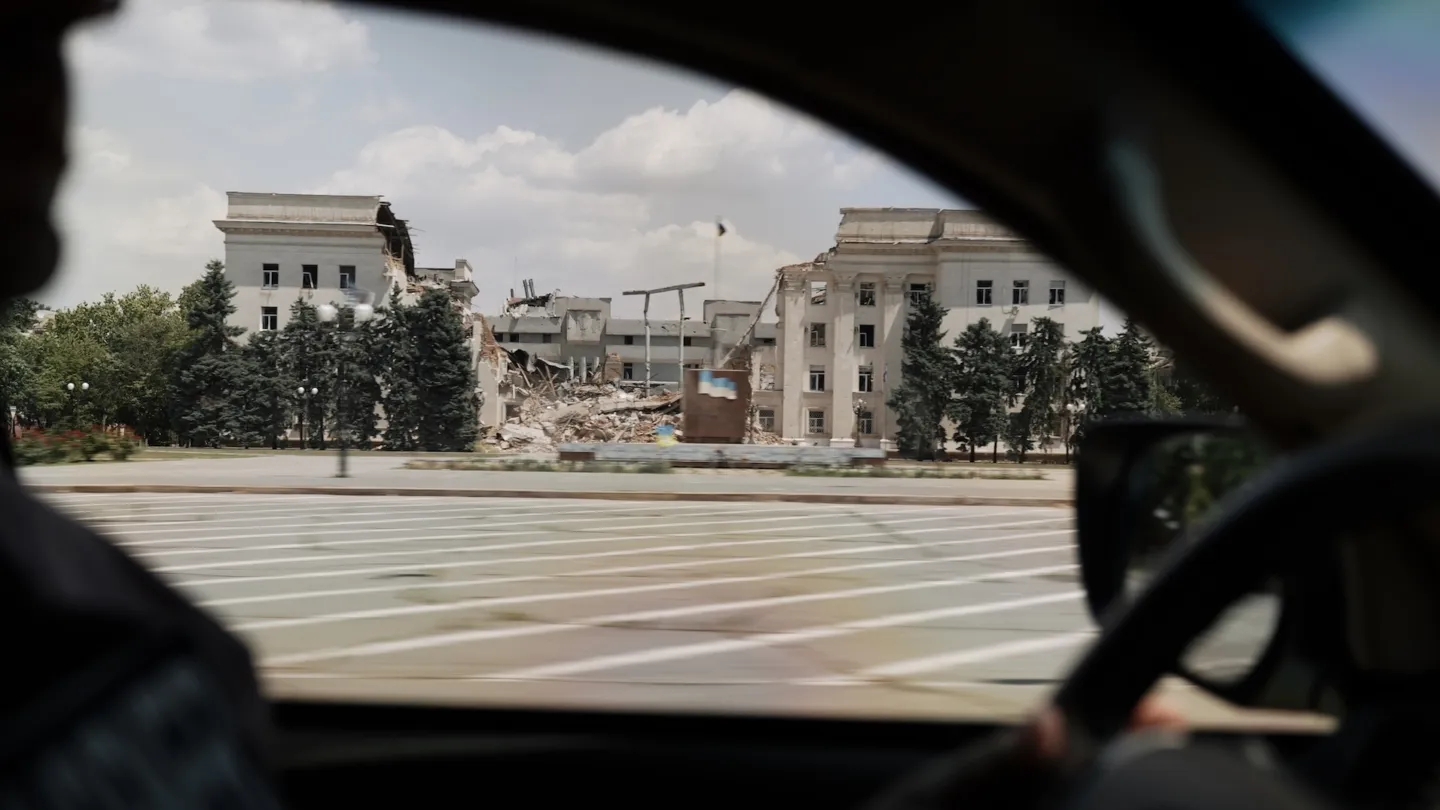 Through a car window, visual of completely destroyed building in Ukraine