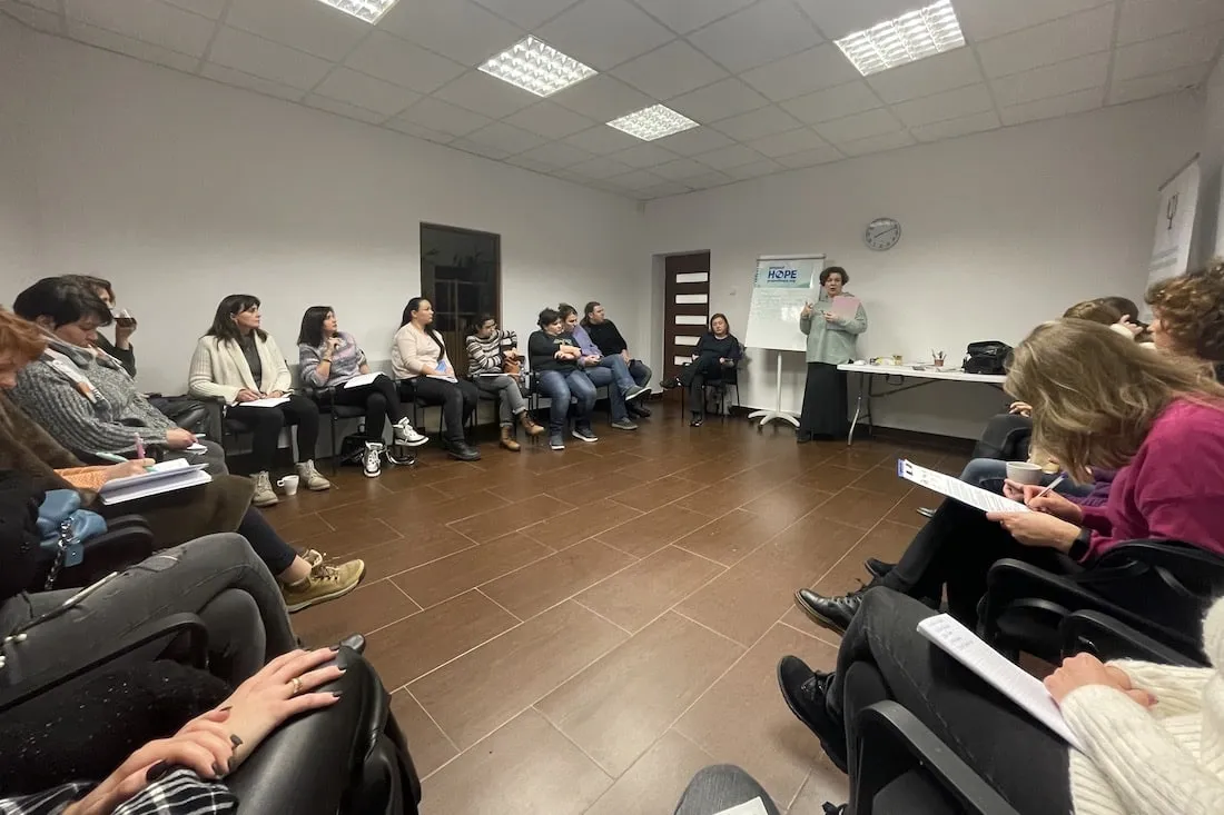 group of people sitting around in a circle