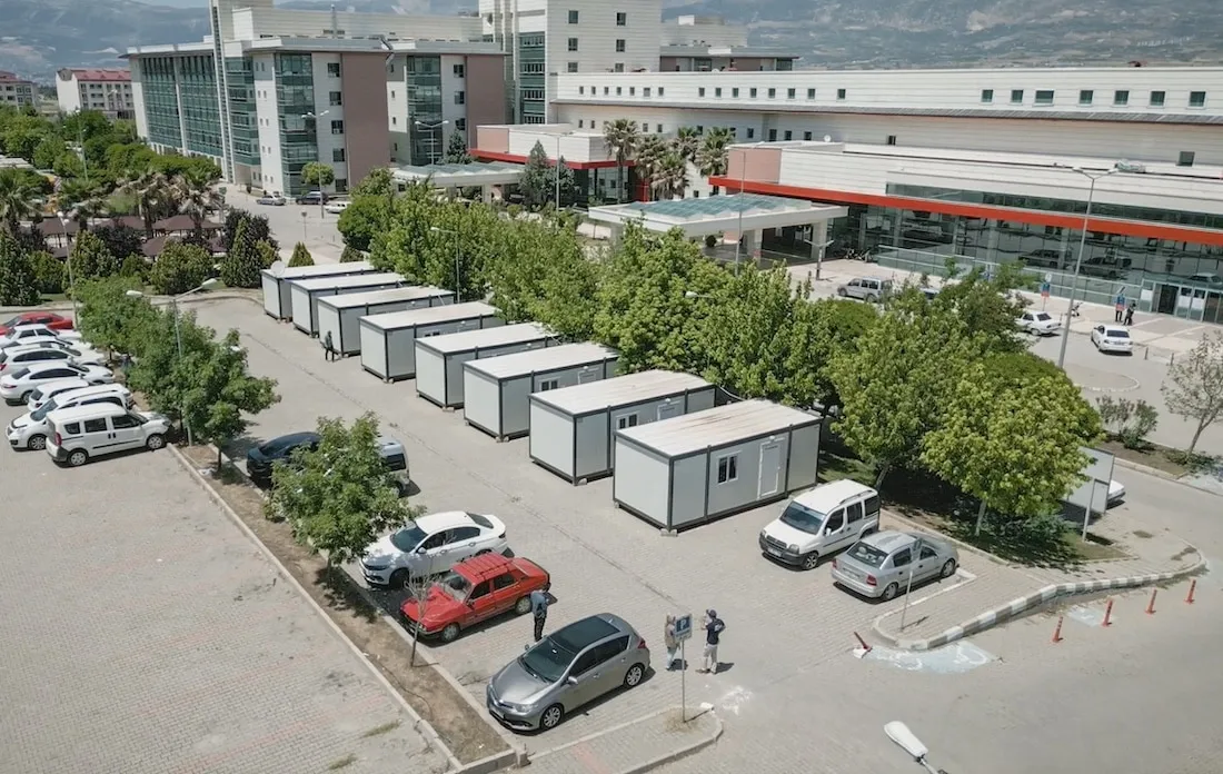 eagle-eye shot of parking lot full of cars and housing containers