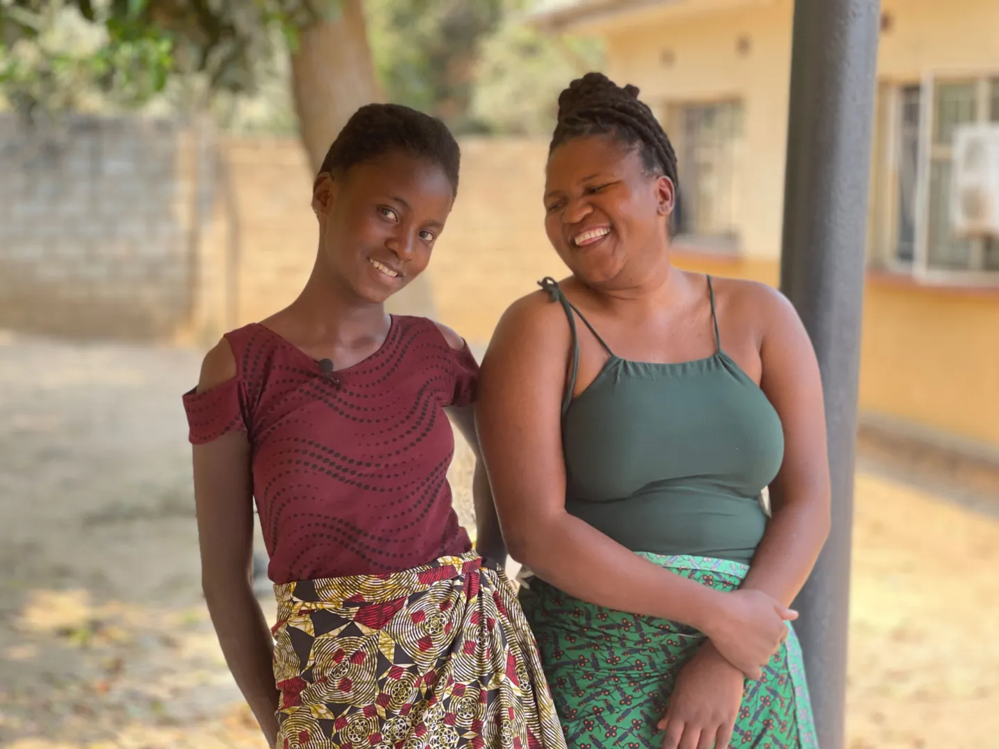 Two women standing together and smiling