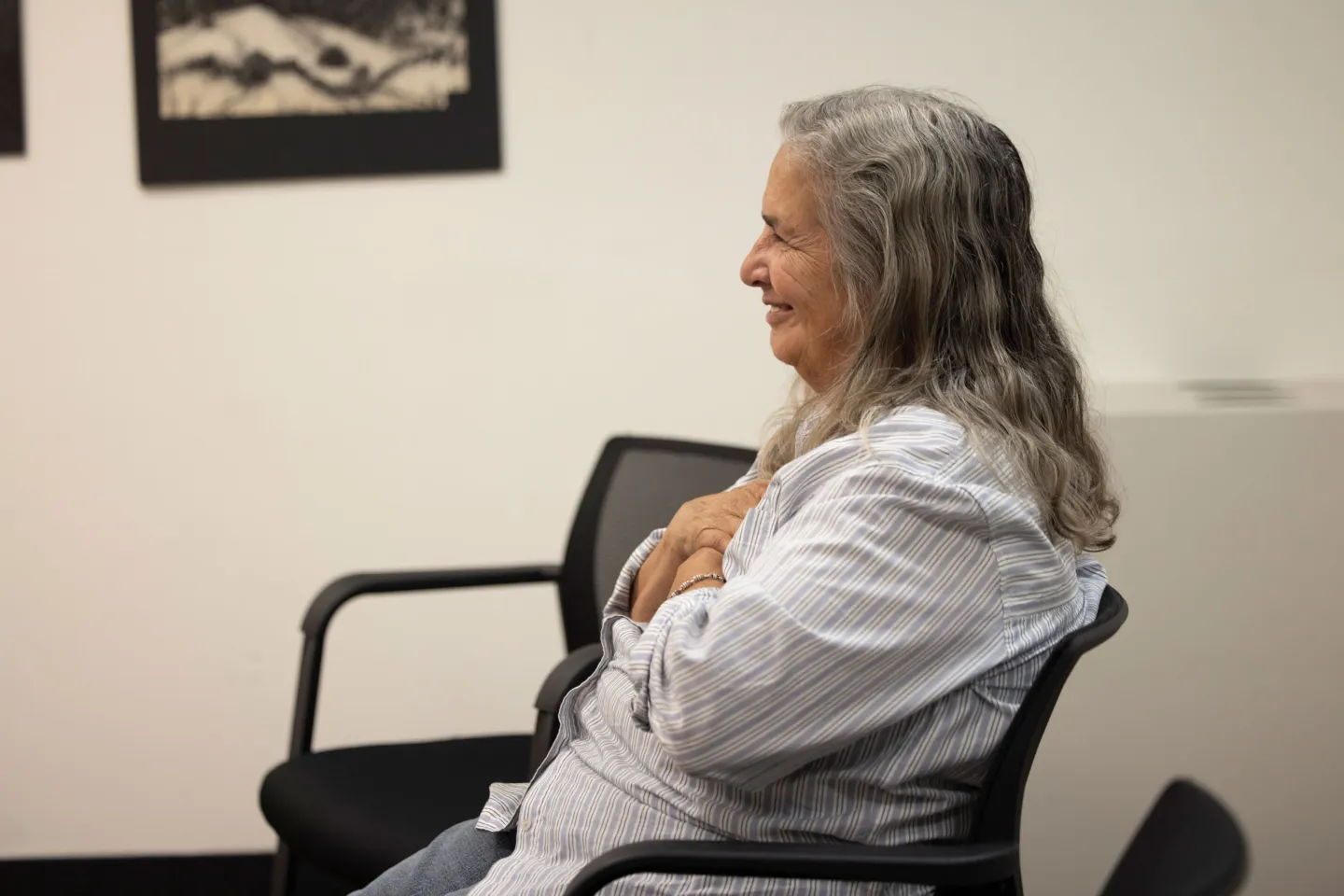 elderly woman meditating in a chair