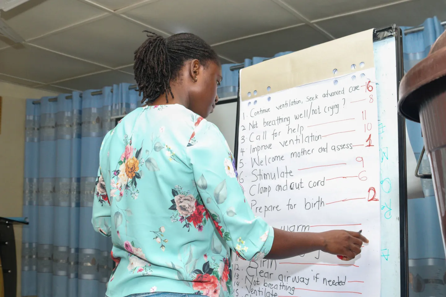 woman in front of board with notes