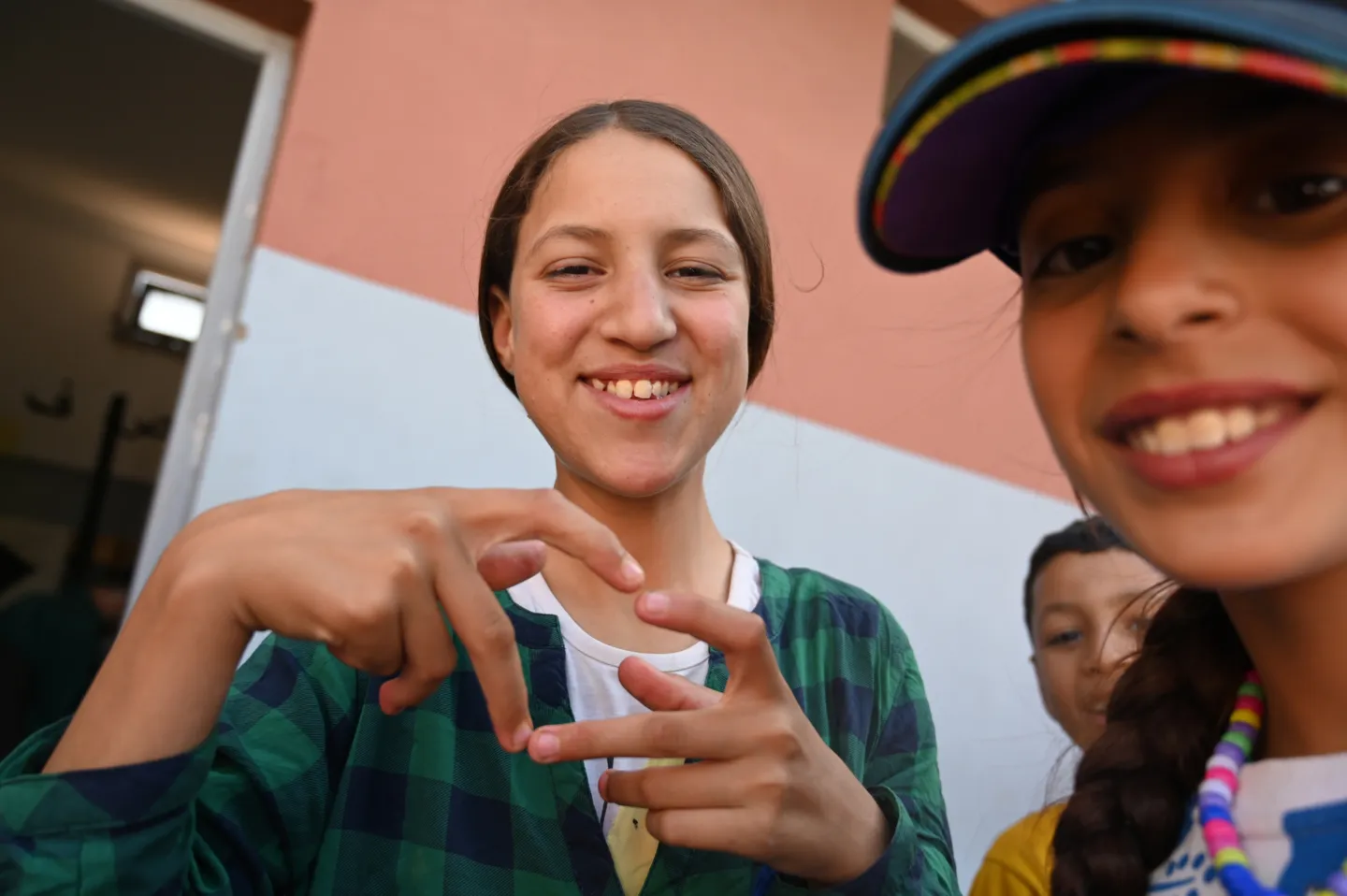 young girl makes a heart with her hands
