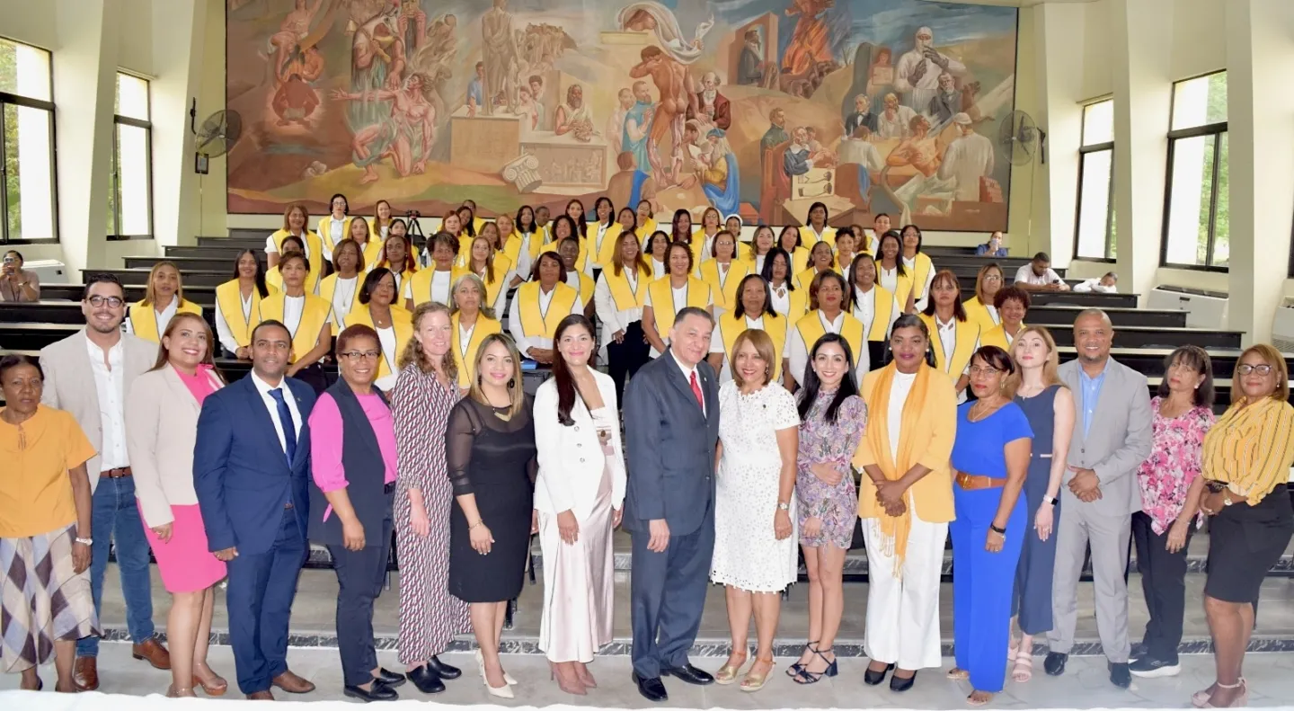 large group of people standing together during a graduation for nurses in the Dominican Republic.