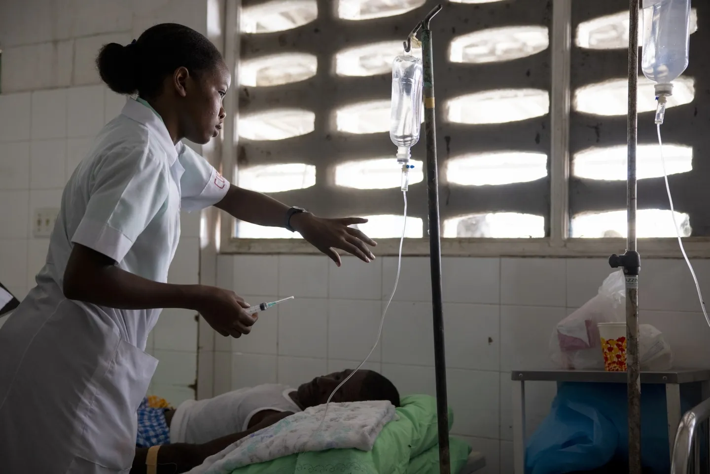 nurse checks vitals of patient