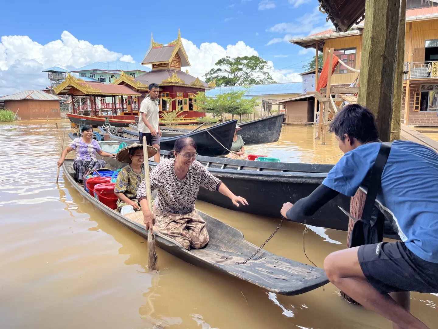 long boat in Myanmar carrying supplies to be distributed to medical staff
