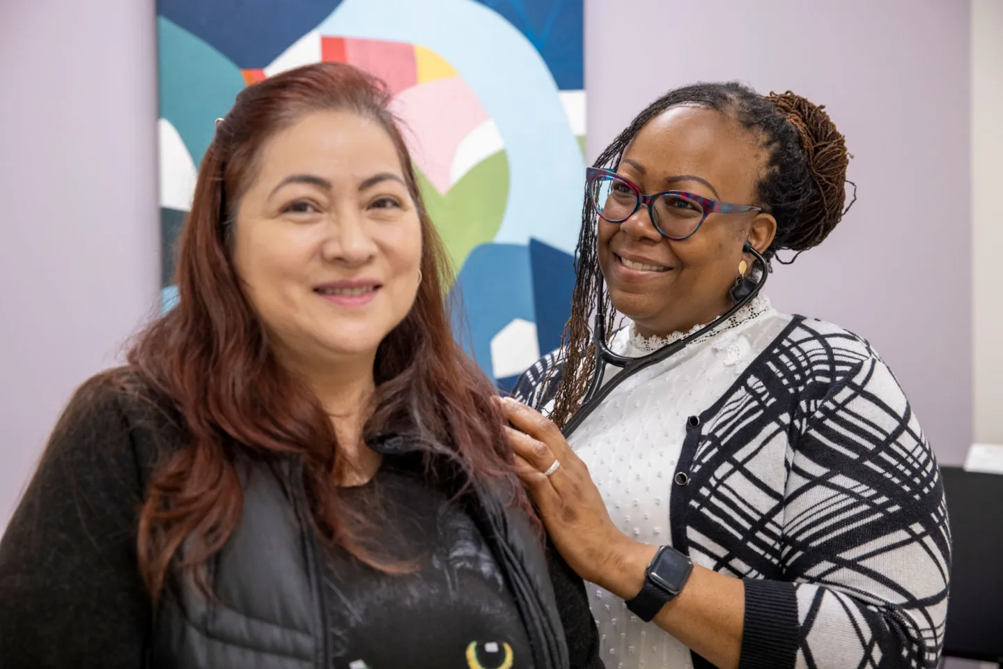 woman checks heartbeat and lungs of patient