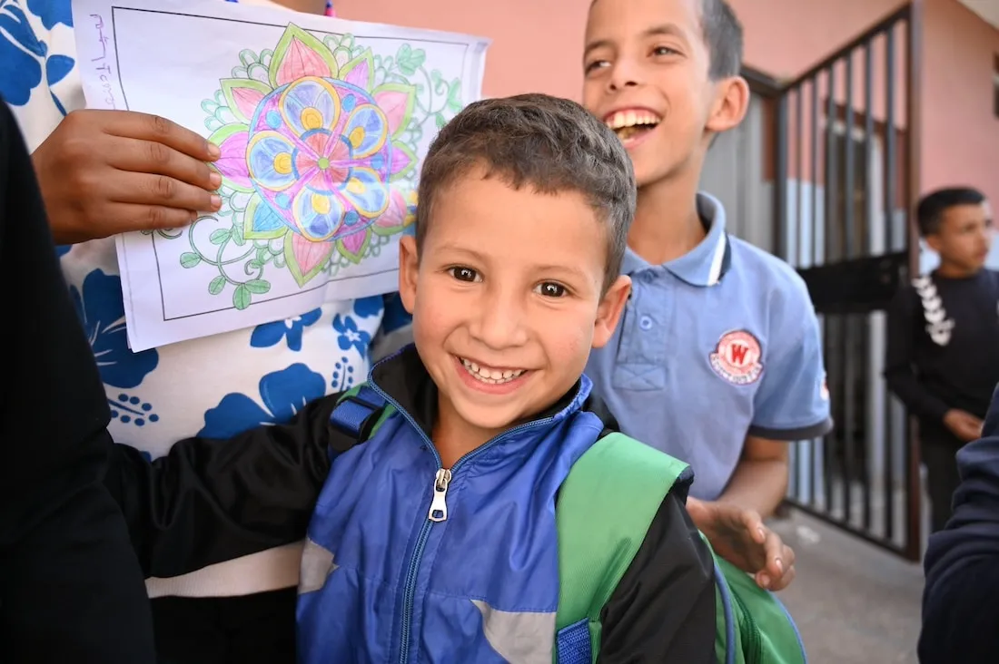 child showing off drawing