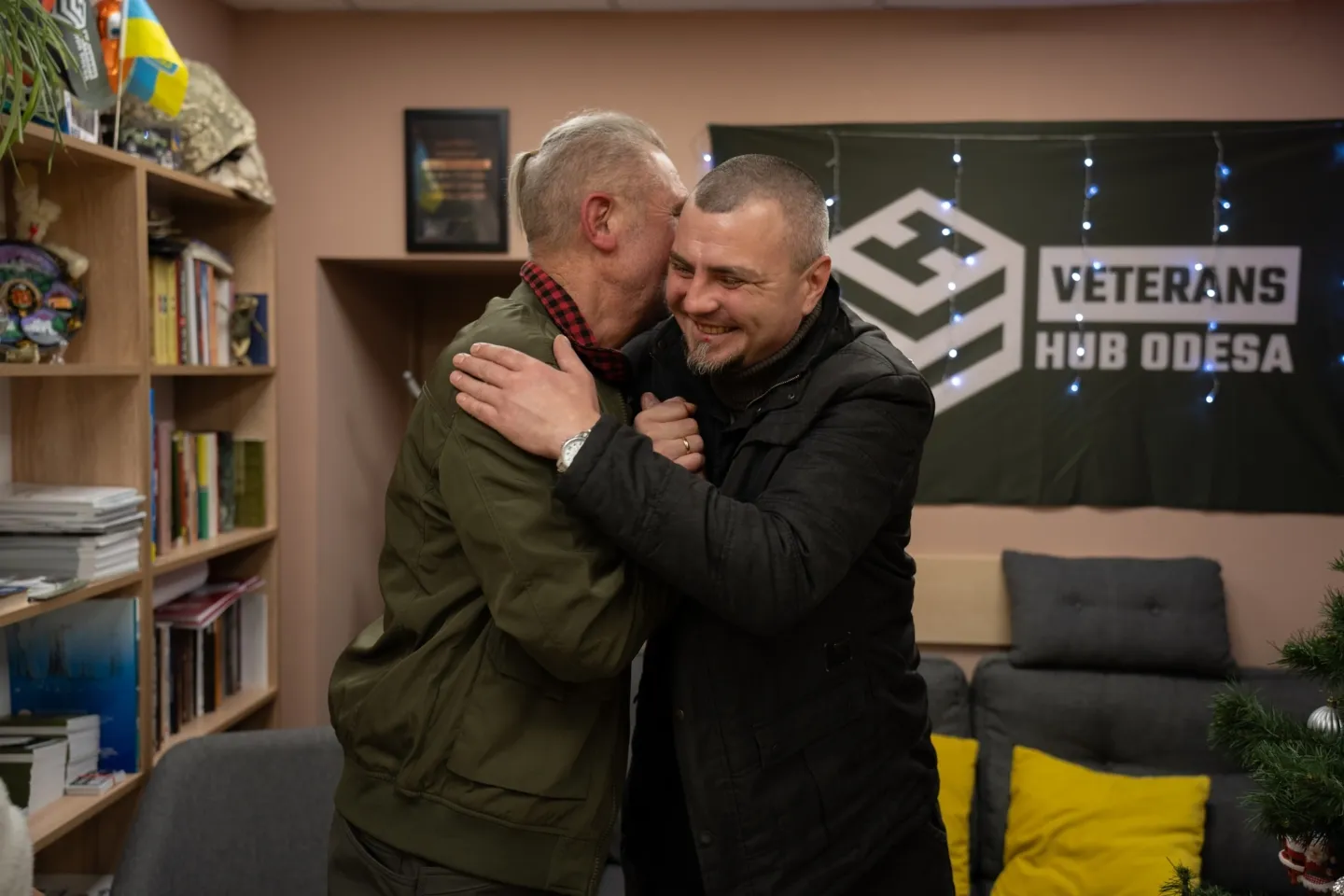 Two men hugging and smiling inside studio in Ukraine