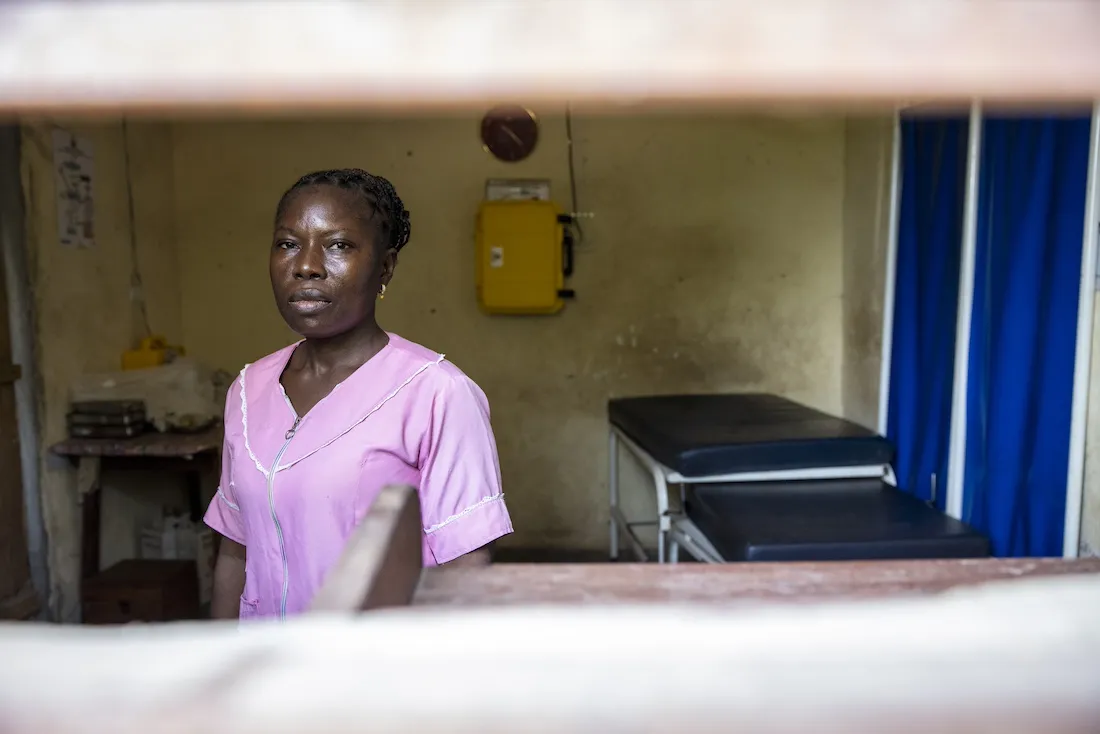 Woman in pink scrubs inside of a maternity ward room