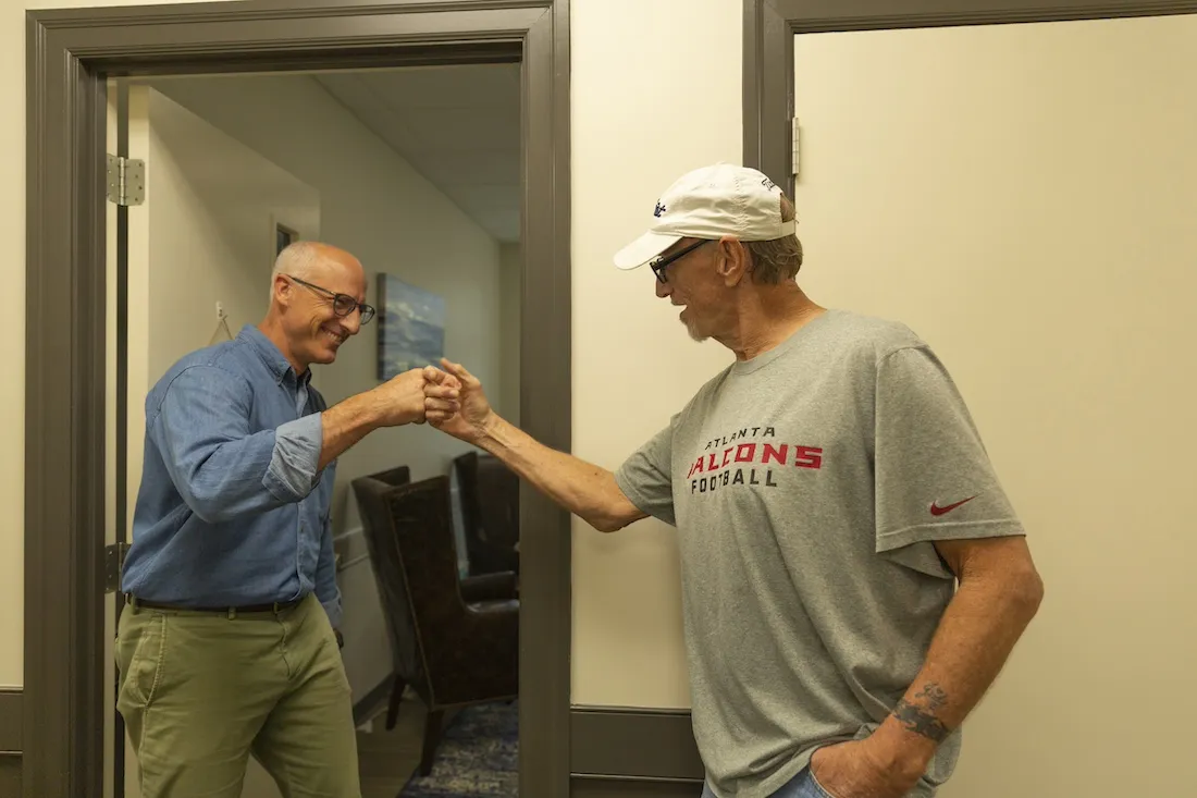 two men fist bumping