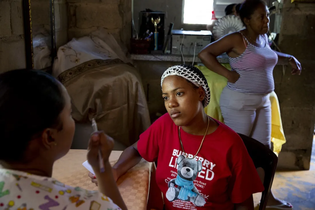 Woman talking to medical staff at table