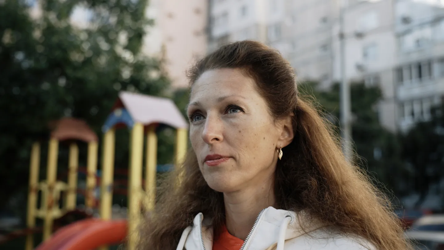 portrait of woman with brown hair standing in a playground