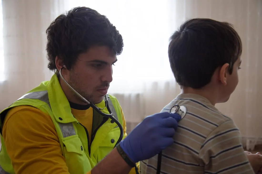Health worker treats child in Moldova