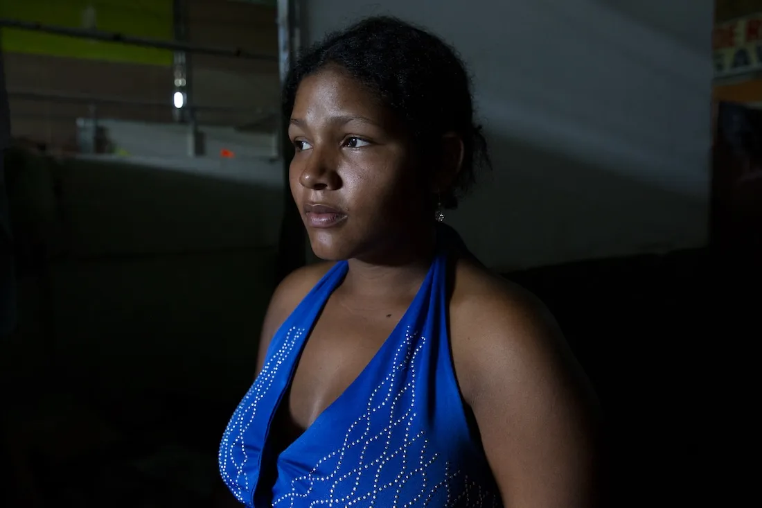 profile of a woman in a blue dress