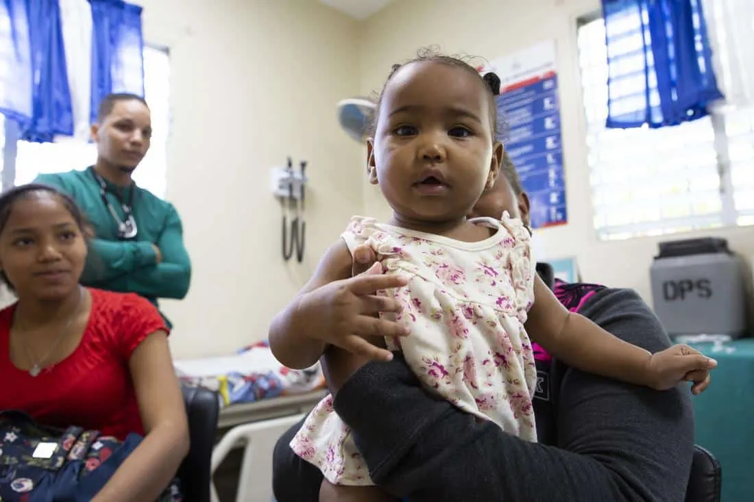 little girl being held up and looking at camera