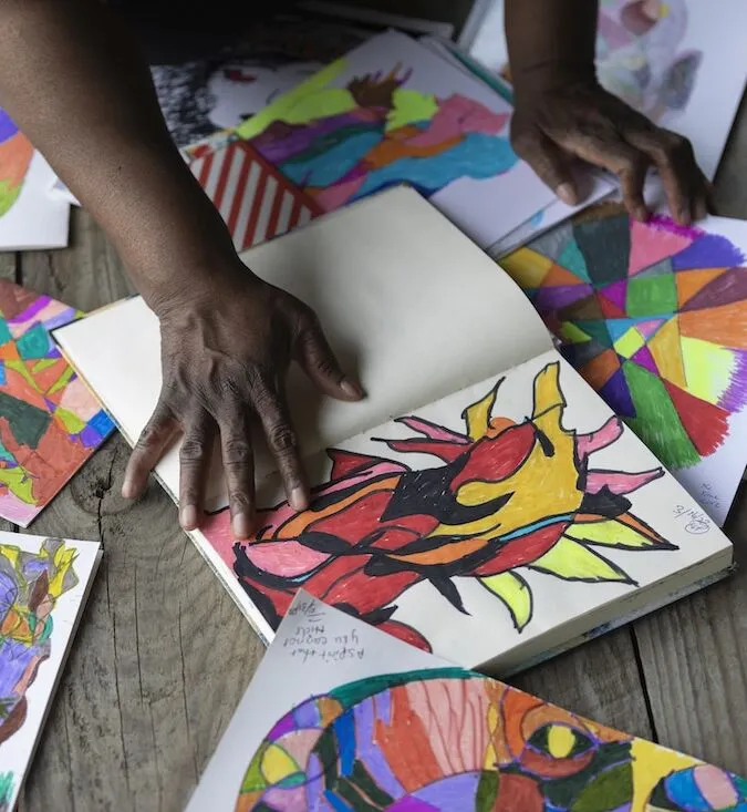 woman's hands surrounding her artwork