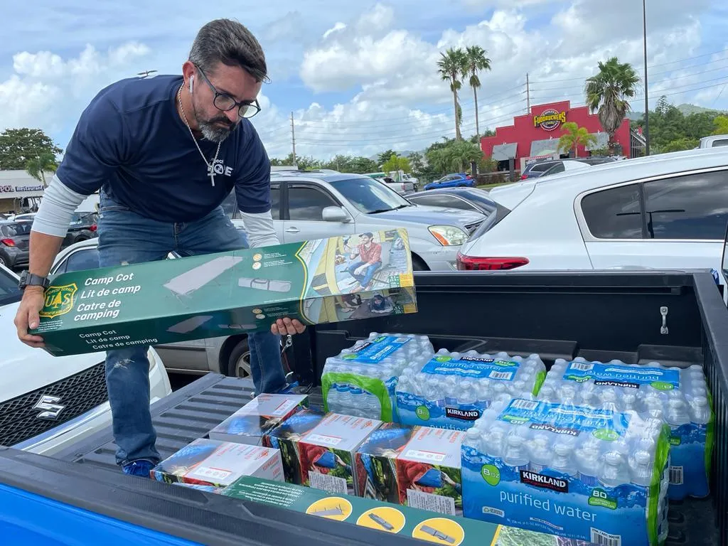 man loading supplies into truck