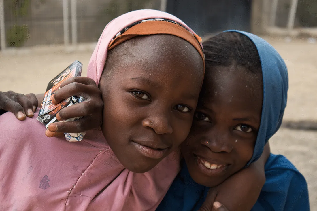 Two young girls hugging