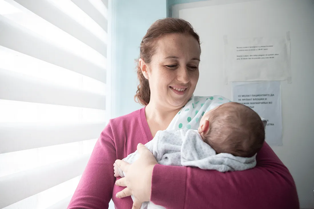 woman holding newborn baby