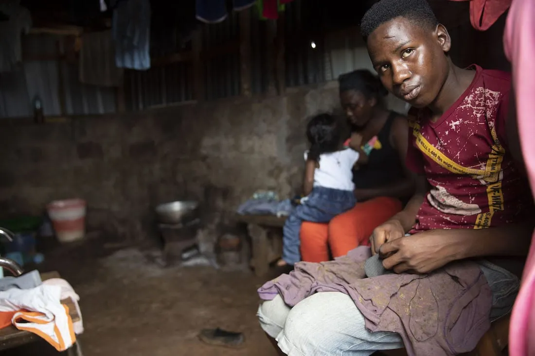 boy sitting inside home with family